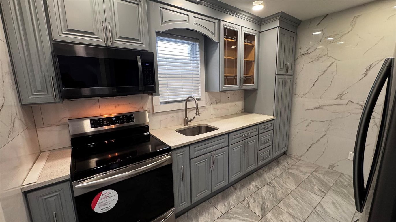 Interior, Kitchen, Marble Walls, Recessed Lighting, Stainless Steel Appliances