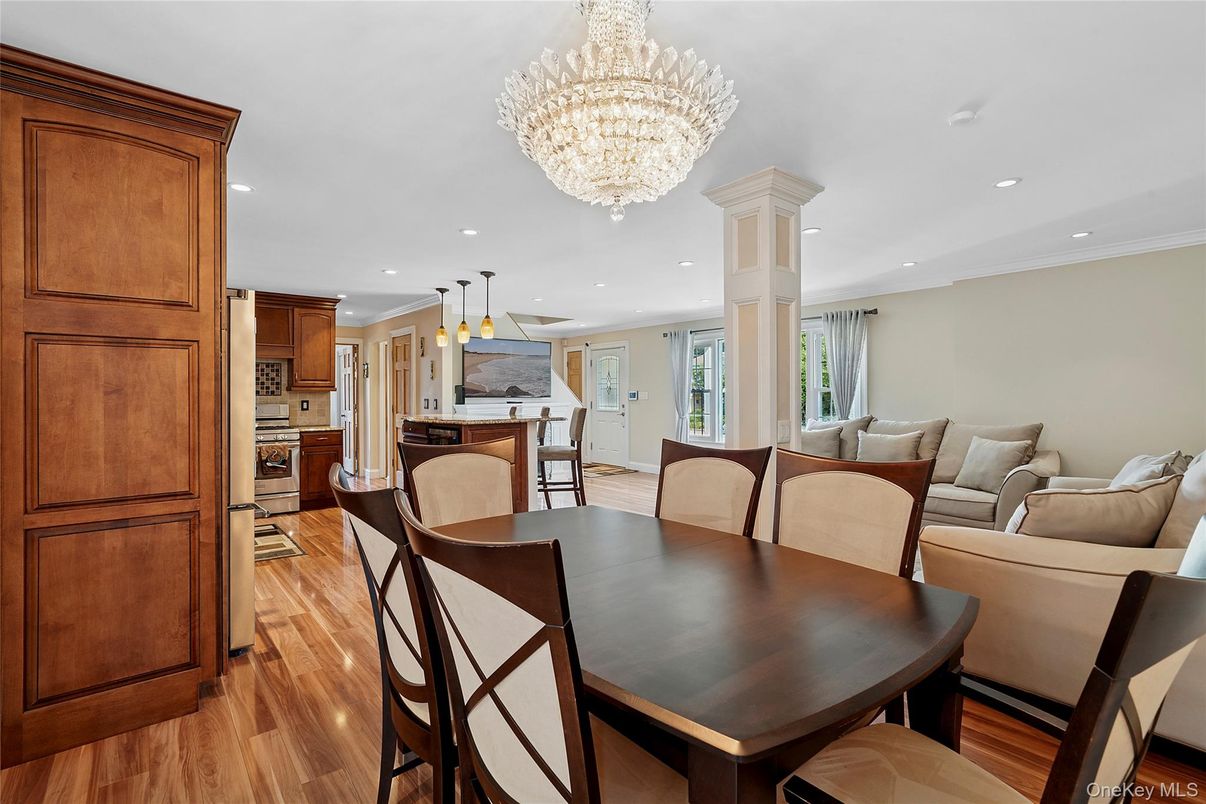 Chandelier, Dining room, Interior, Kitchen, Living room, Pendant Lights, Recessed Lighting, Stainless Steel Appliances, Wood Texture Flooring