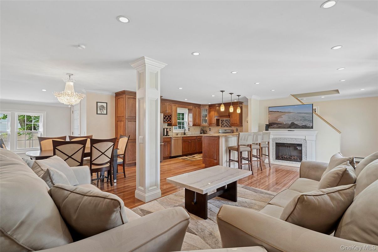 Chandelier, Dining room, Fireplace, Interior, Kitchen, Living room, Pendant Lights, Recessed Lighting, Stainless Steel Appliances, Wood Texture Flooring