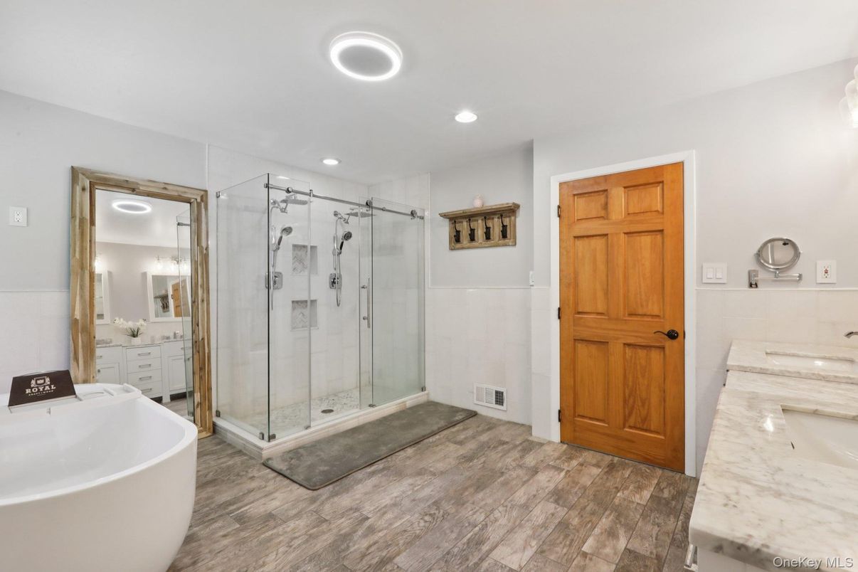 Bathroom, Dual Sink Vanities, Free Standing Baths, Glass Shower, Interior, Recessed Lighting, Wood Texture Flooring