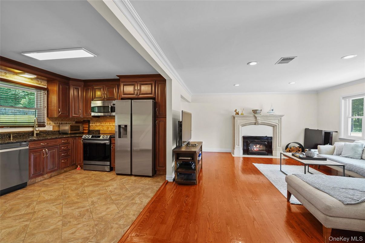Fireplace, Interior, Kitchen, Living room, Recessed Lighting, Stainless Steel Appliances, Wood Texture Flooring