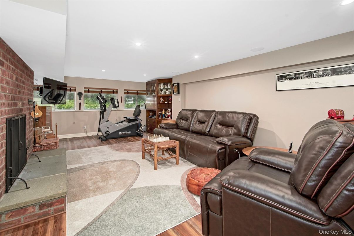 Fireplace, Fitness Equipment, Interior, Living room, Recessed Lighting, Stone Walls, Wood Texture Flooring