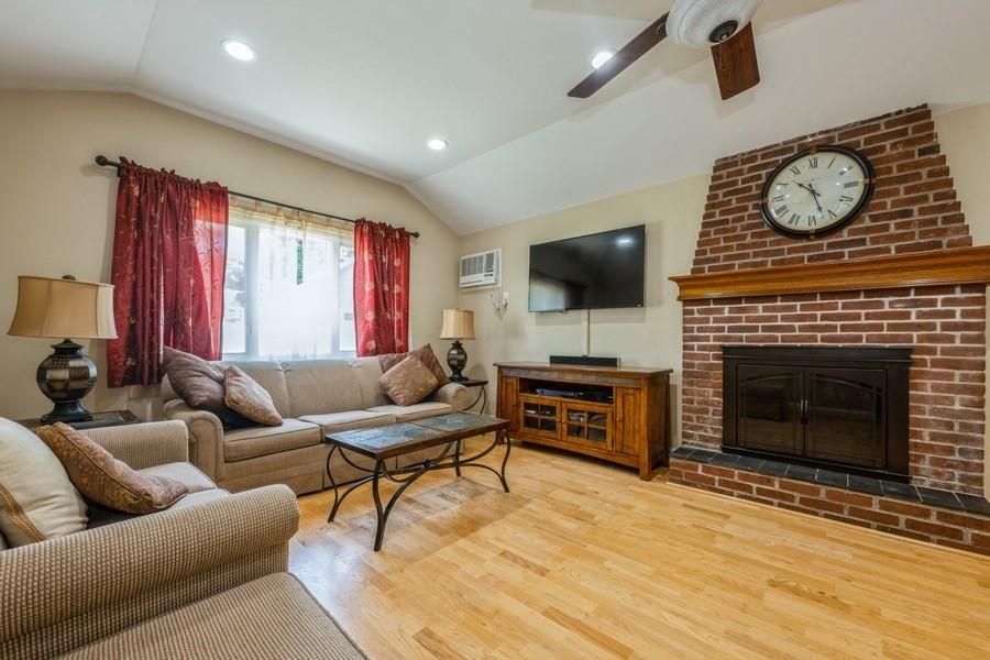 Fireplace, Interior, Living room, Recessed Lighting, Stone Walls, Wood Texture Flooring