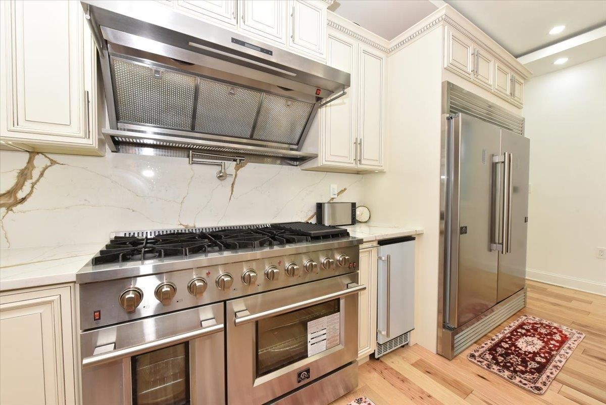 Interior, Kitchen, Marble Walls, Recessed Lighting, Stainless Steel Appliances, Wood Texture Flooring