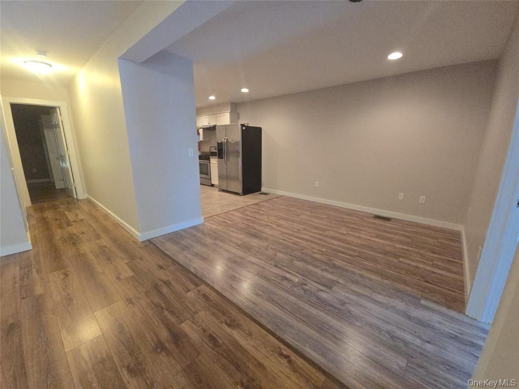 Empty room, Interior, Kitchen, Recessed Lighting, Stainless Steel Appliances, Wood Texture Flooring