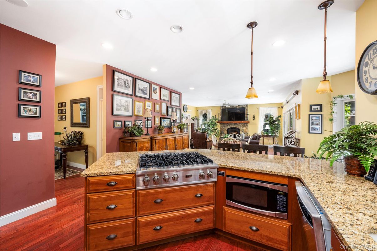 Dining room, Fireplace, Interior, Kitchen, Living room, Pendant Lights, Recessed Lighting, Stainless Steel Appliances, Wood Texture Flooring