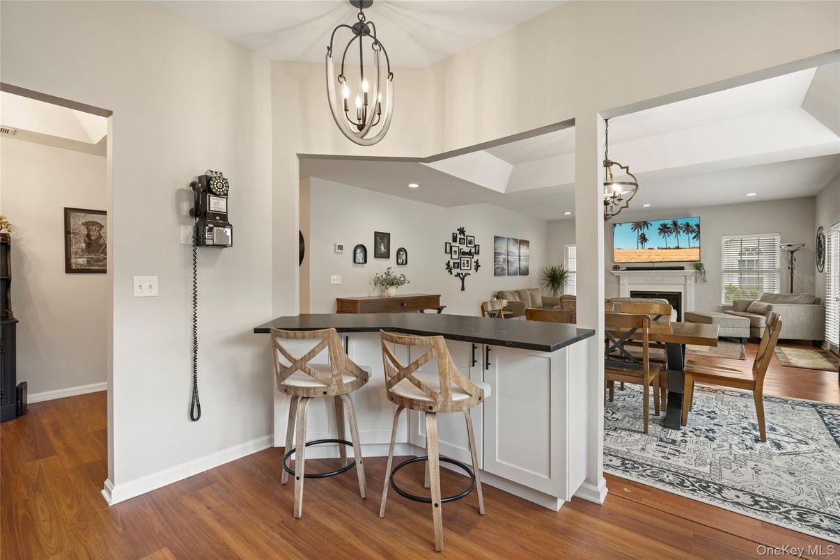 Chandelier, Dining room, Fireplace, Interior, Living room, Pendant Lights, Recessed Lighting, Wood Texture Flooring