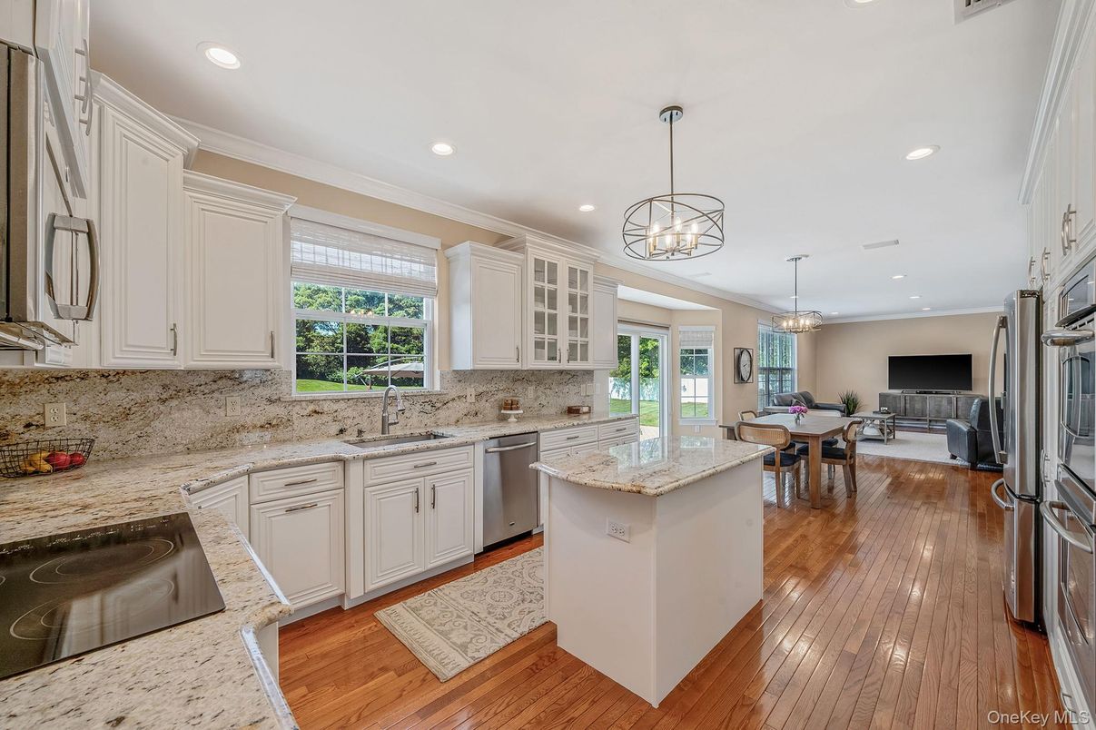 Chandelier, Dining room, Interior, Kitchen, Pendant Lights, Recessed Lighting, Stainless Steel Appliances, Wood Texture Flooring