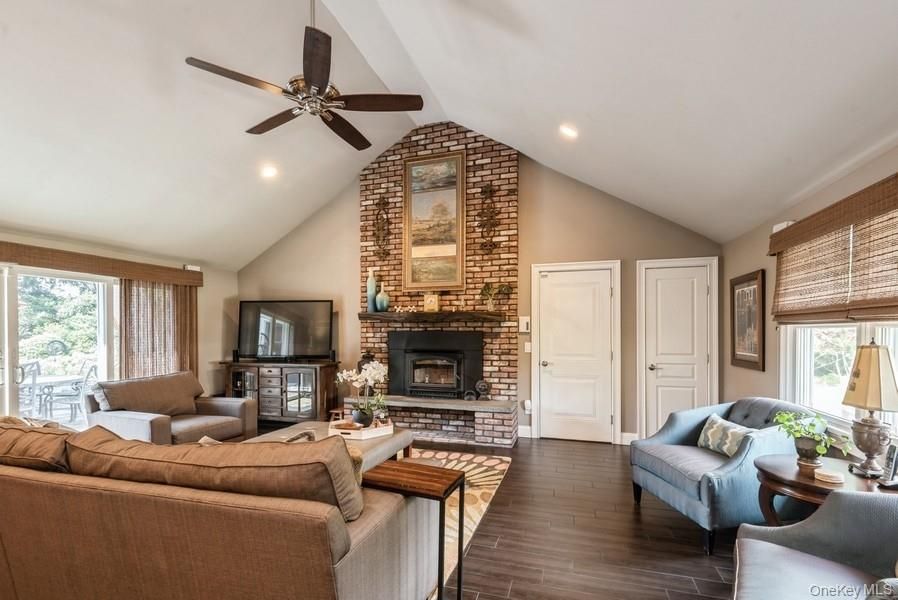 Fireplace, Interior, Living room, Recessed Lighting, Stone Walls, Wood Texture Flooring