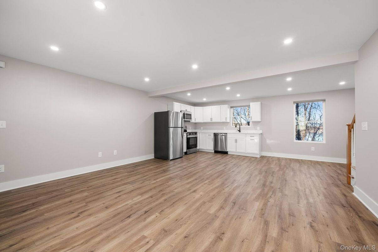 Empty room, Interior, Kitchen, Recessed Lighting, Stainless Steel Appliances, Wood Texture Flooring