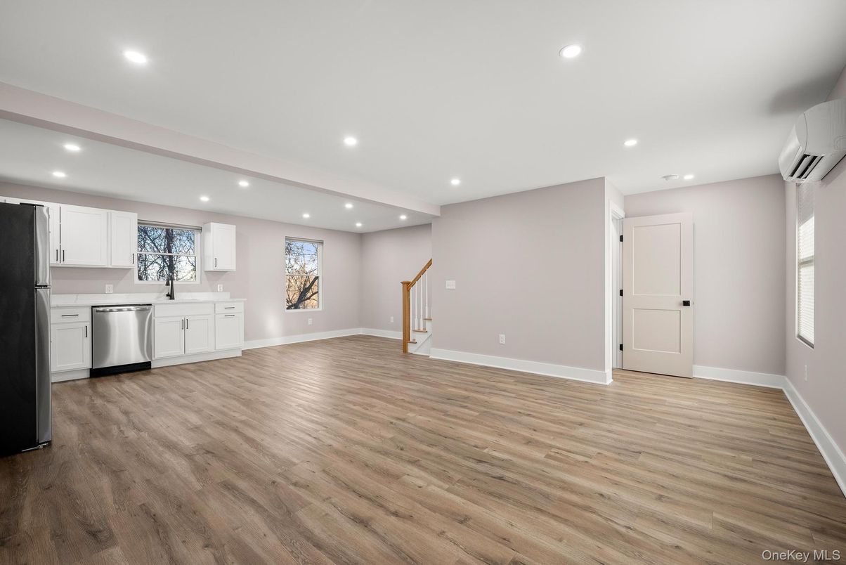 Empty room, Interior, Kitchen, Recessed Lighting, Stainless Steel Appliances, Wood Texture Flooring
