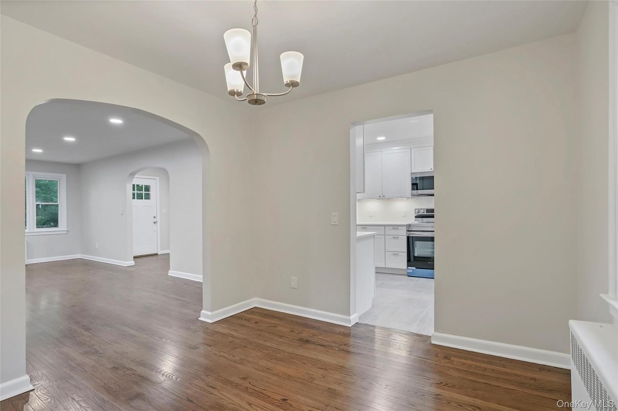 Chandelier, Empty room, Interior, Kitchen, Recessed Lighting, Stainless Steel Appliances, Wood Texture Flooring