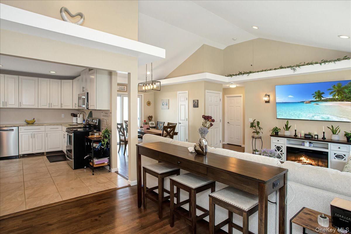 Dining room, Fireplace, Interior, Kitchen, Living room, Pendant Lights, Recessed Lighting, Stainless Steel Appliances, Wood Texture Flooring