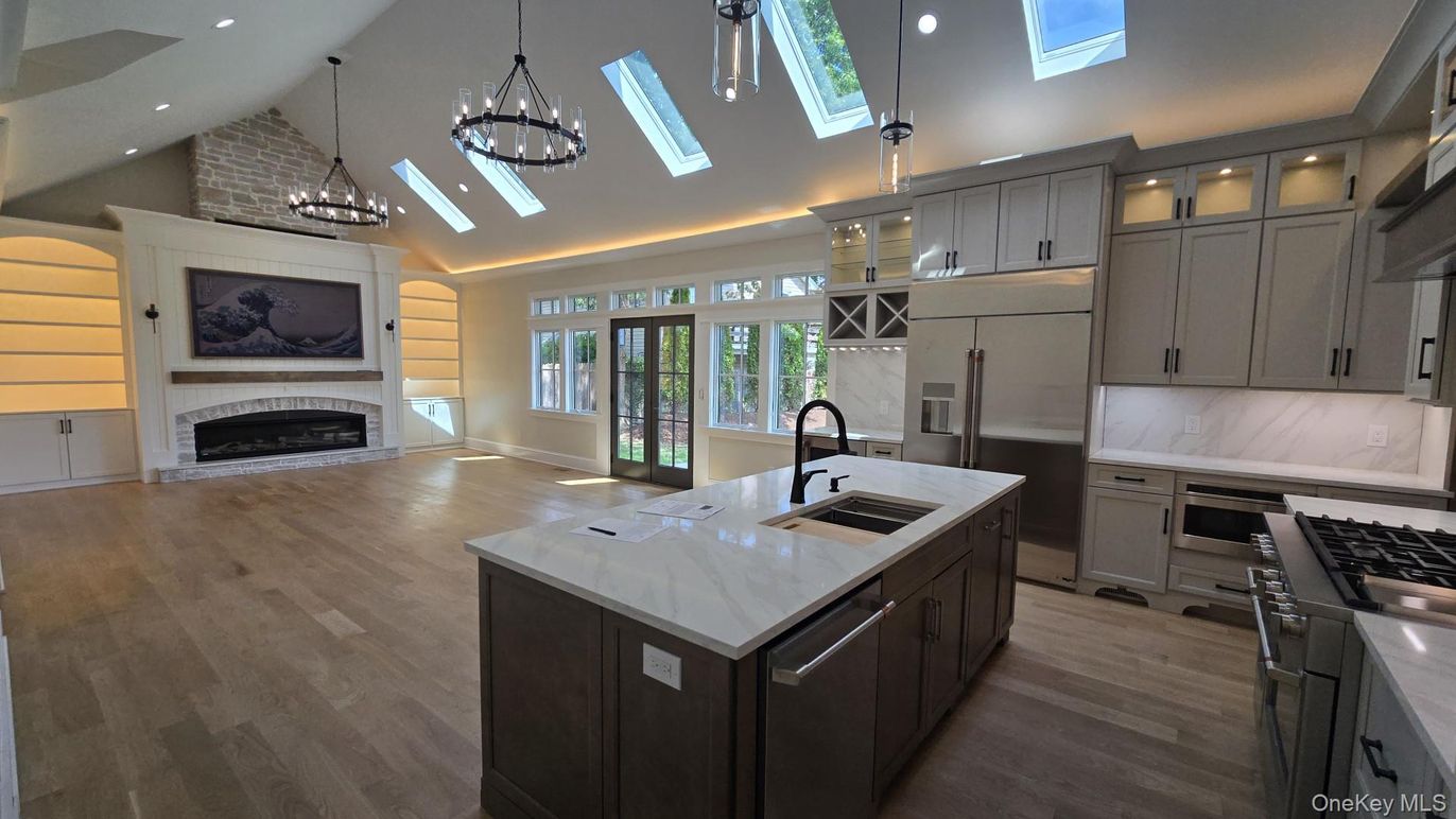 Chandelier, Fireplace, Interior, Kitchen, Pendant Lights, Recessed Lighting, Stainless Steel Appliances, Wood Texture Flooring
