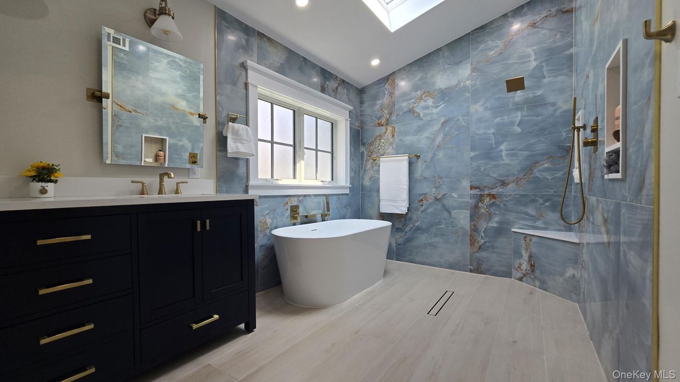 Bathroom, Dual Sink Vanities, Free Standing Baths, Interior, Marble Walls, Recessed Lighting, Wood Texture Flooring