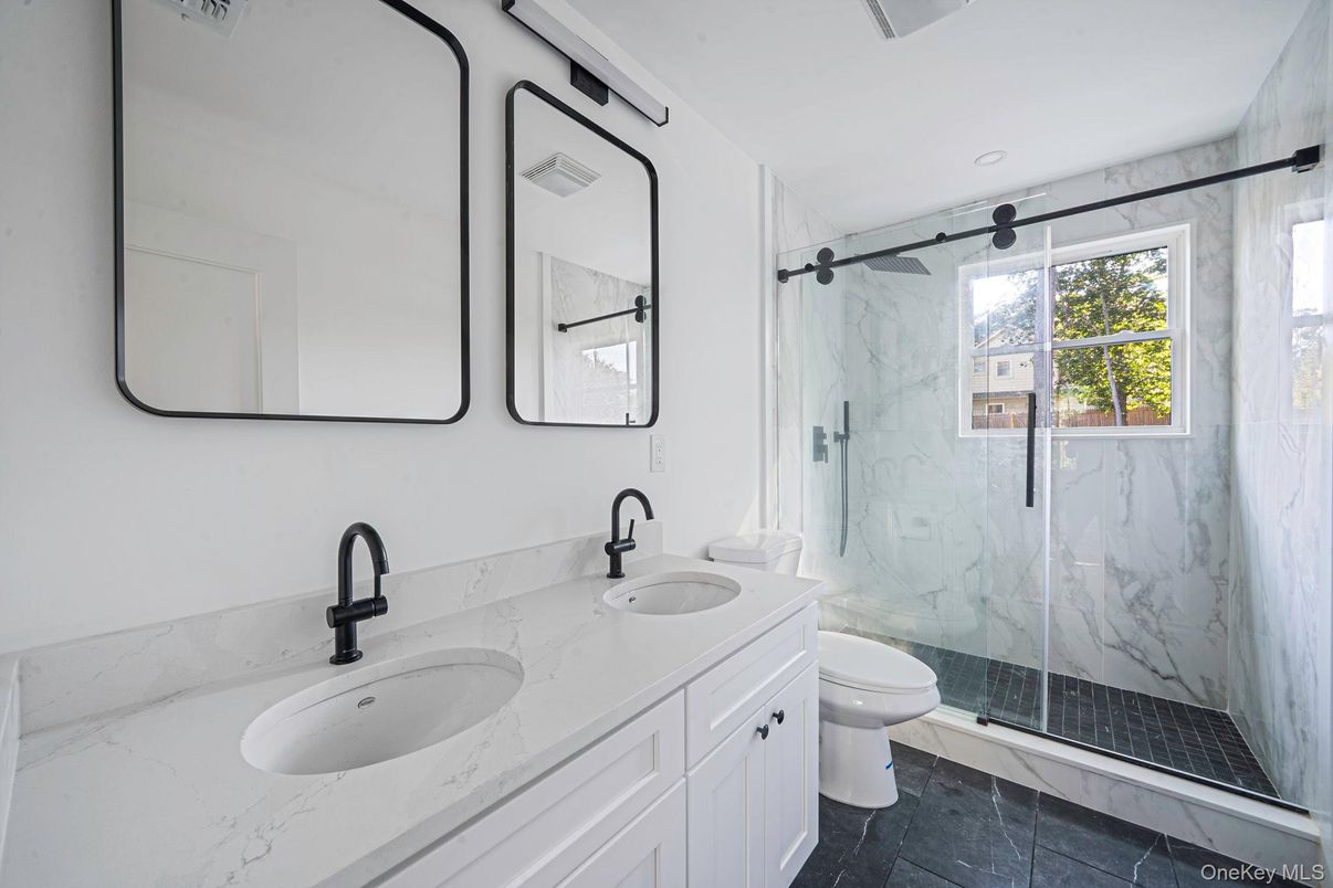 Bathroom, Dual Sink Vanities, Glass Shower, Interior, Marble Walls, Recessed Lighting