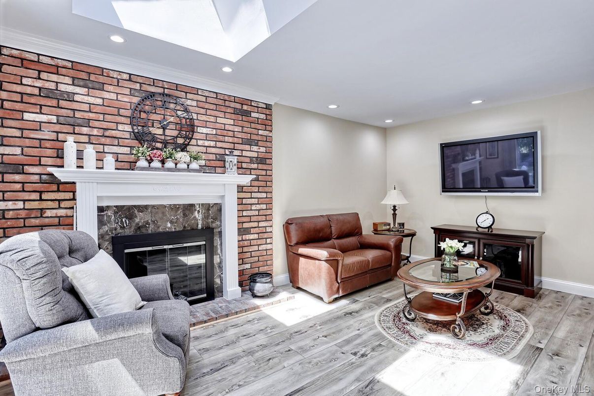 Fireplace, Interior, Living room, Recessed Lighting, Stone Walls, Wood Texture Flooring