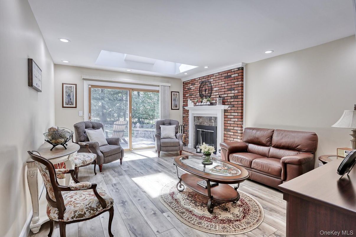 Fireplace, Interior, Living room, Recessed Lighting, Stone Walls, Wood Texture Flooring