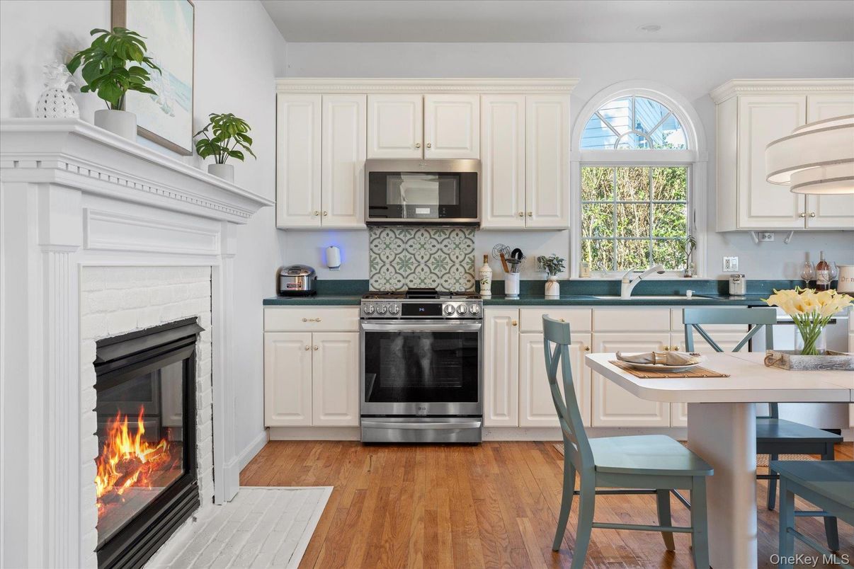 Dining room, Fireplace, Interior, Kitchen, Stainless Steel Appliances, Wood Texture Flooring