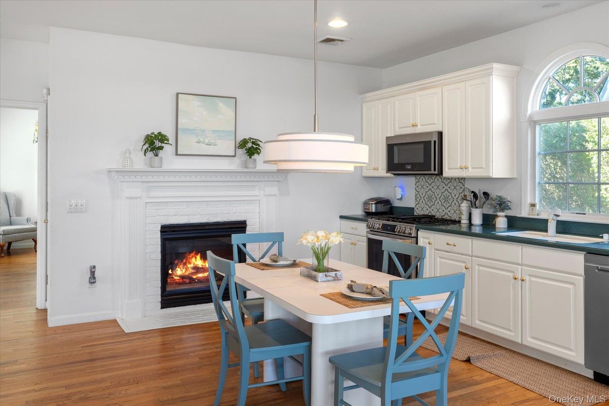Dining room, Fireplace, Interior, Kitchen, Pendant Lights, Recessed Lighting, Stainless Steel Appliances, Wood Texture Flooring