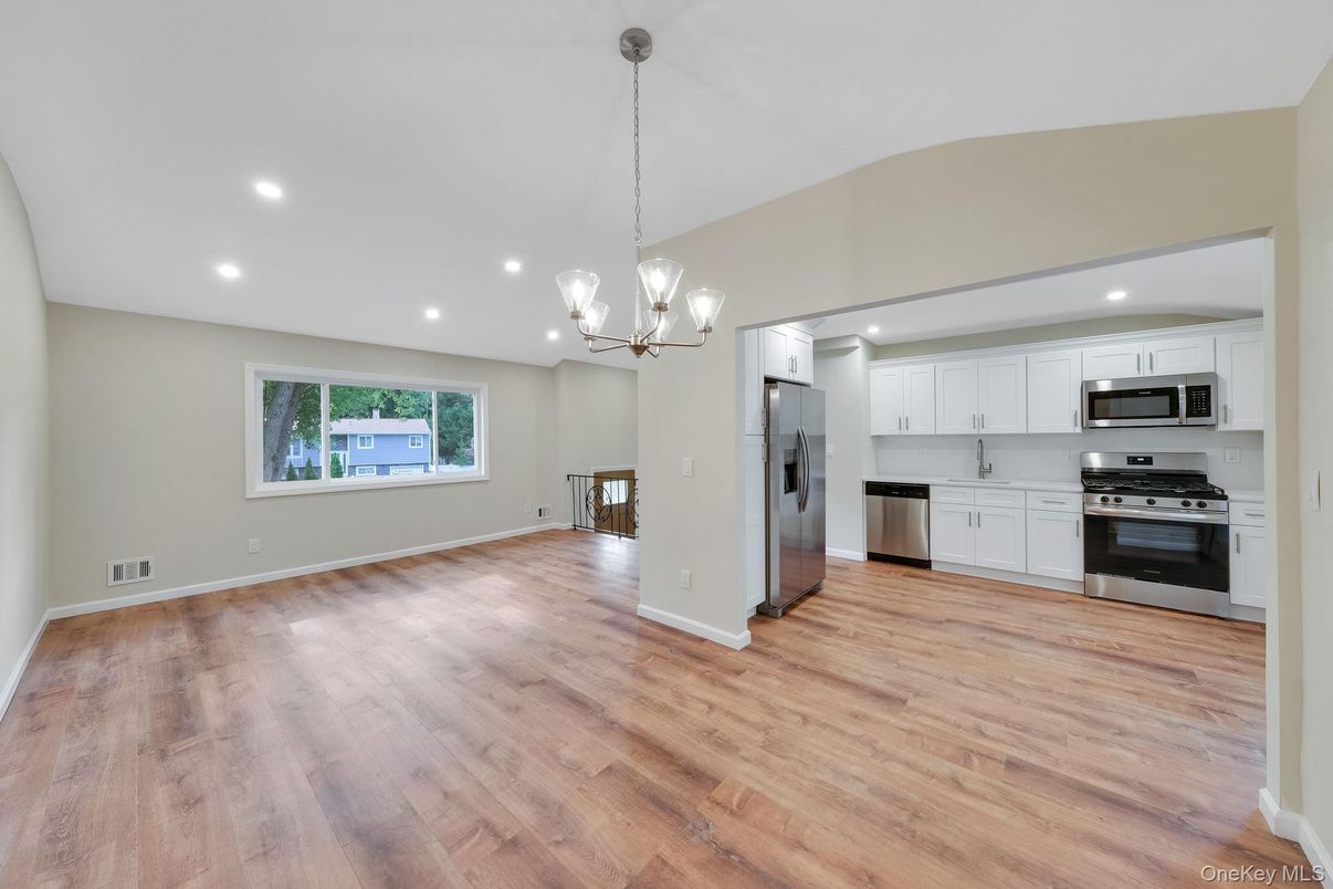Chandelier, Empty room, Interior, Kitchen, Pendant Lights, Recessed Lighting, Stainless Steel Appliances, Wood Texture Flooring