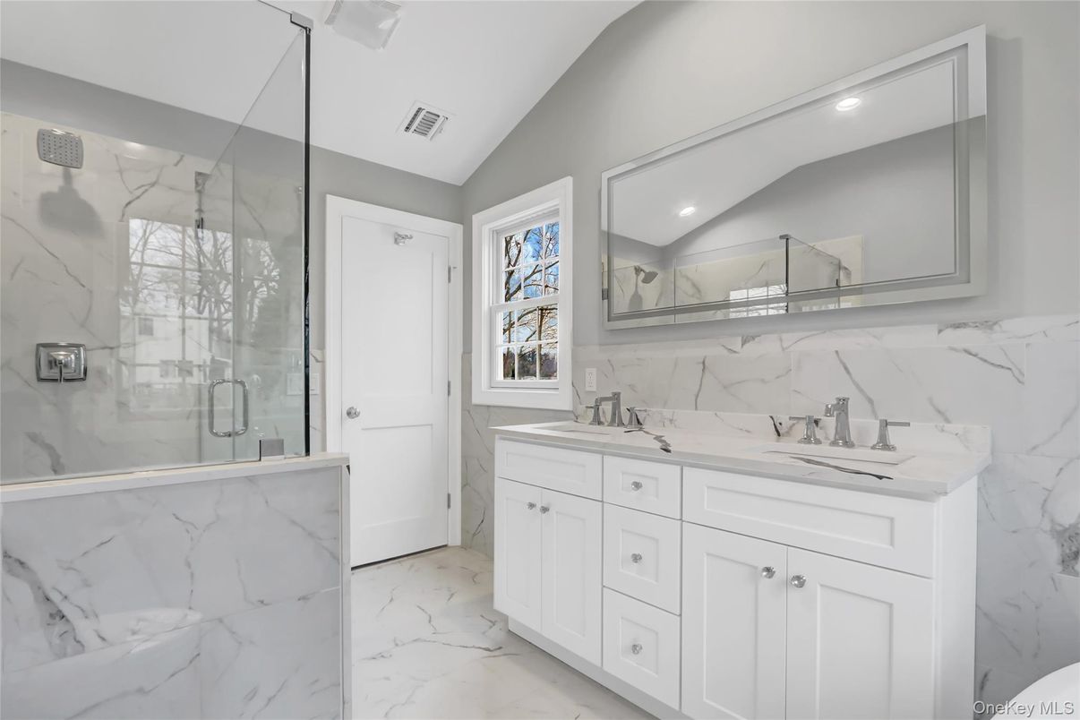 Bathroom, Dual Sink Vanities, Glass Shower, Interior, Marble, Marble Walls, Recessed Lighting