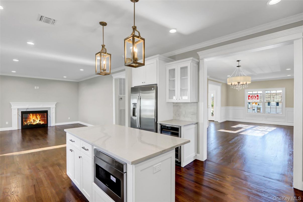 Chandelier, Fireplace, Interior, Kitchen, Pendant Lights, Recessed Lighting, Stainless Steel Appliances, Wood Texture Flooring