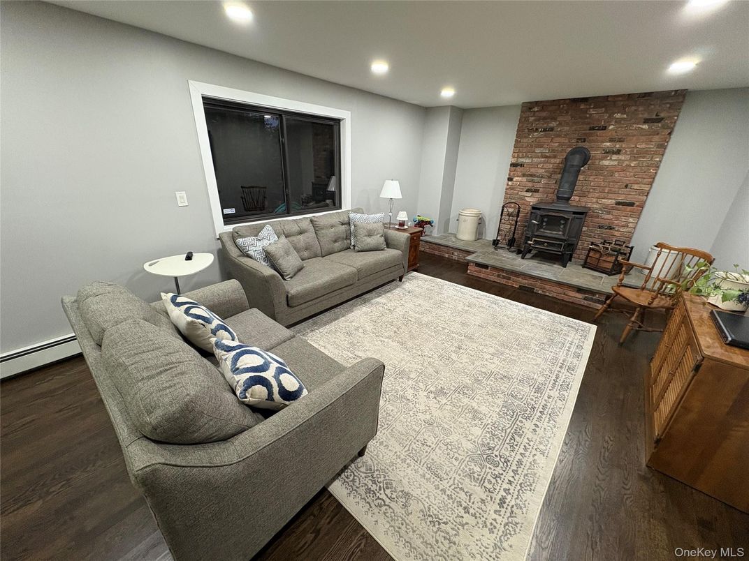 Fireplace, Interior, Living room, Recessed Lighting, Stone Walls, Wood Texture Flooring