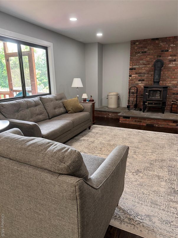 Fireplace, Interior, Living room, Recessed Lighting, Stone Walls, Wood Texture Flooring