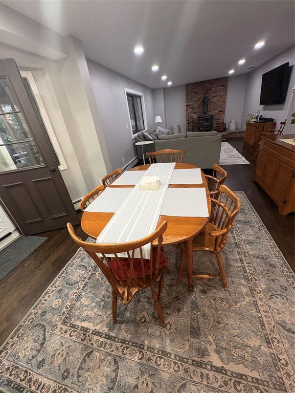 Dining room, Fireplace, Interior, Living room, Recessed Lighting, Stone Walls, Wood Texture Flooring