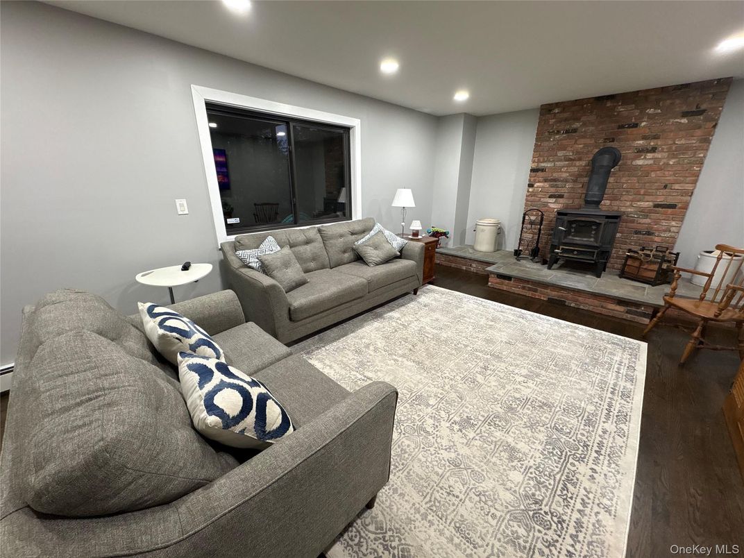 Fireplace, Interior, Living room, Recessed Lighting, Stone Walls, Wood Texture Flooring