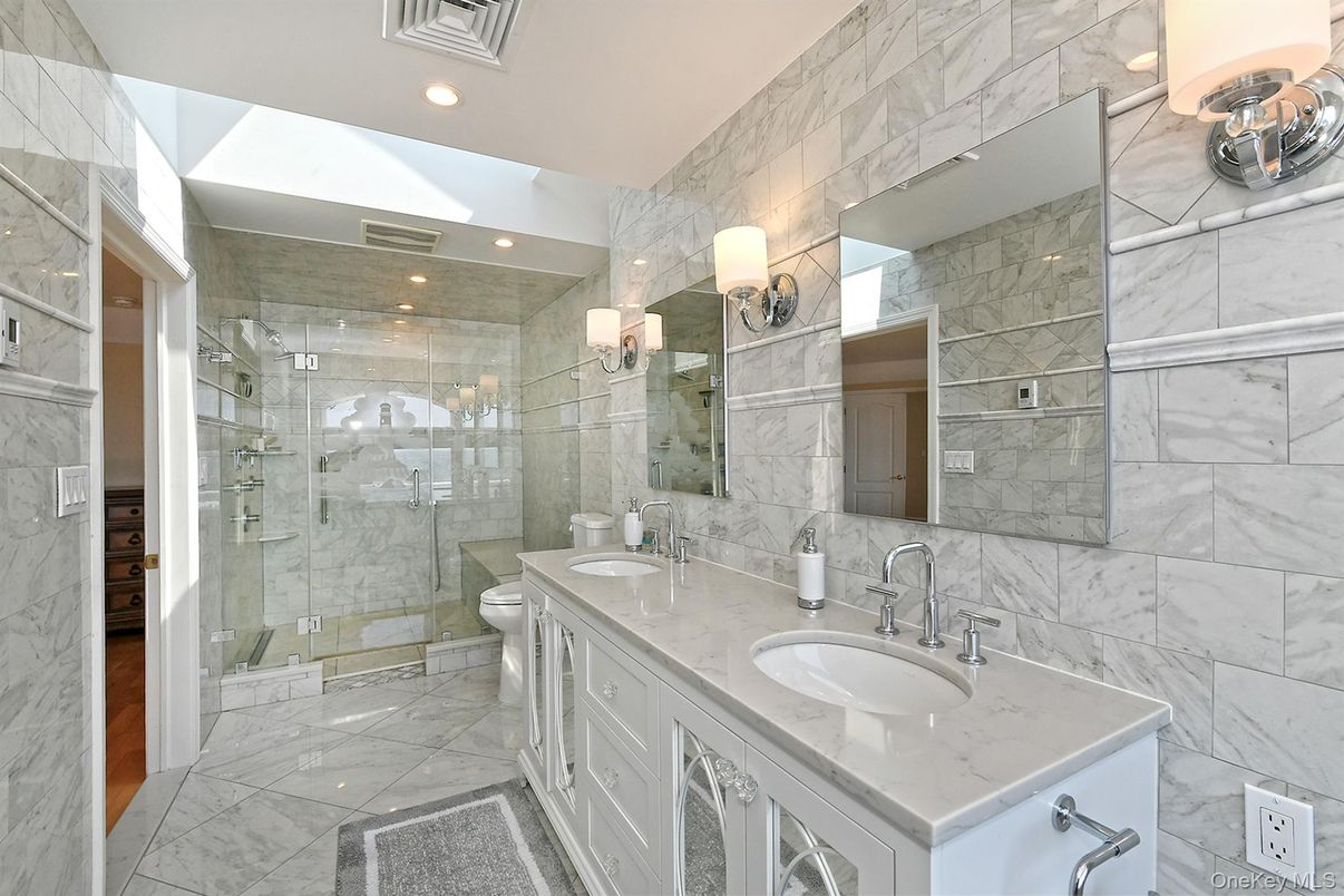 Bathroom, Dual Sink Vanities, Glass Shower, Interior, Marble, Marble Walls, Recessed Lighting