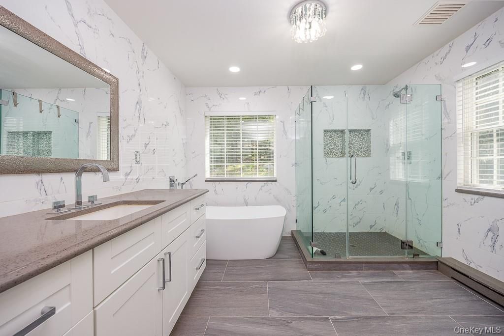 Bathroom, Dual Sink Vanities, Free Standing Baths, Glass Shower, Interior, Marble Walls, Recessed Lighting