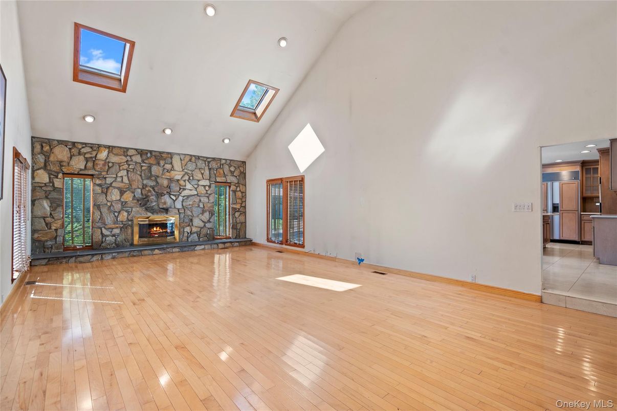 Empty room, Fireplace, Interior, Recessed Lighting, Stone Walls, Wood Texture Flooring