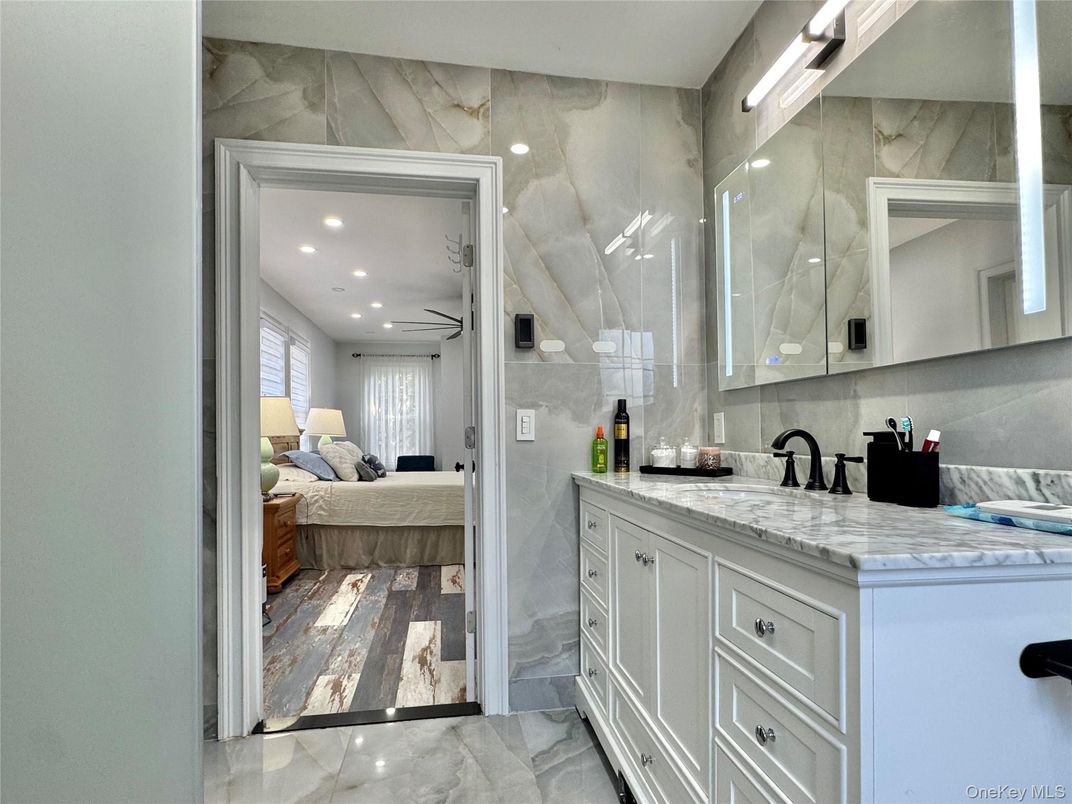 Bathroom, Bedroom, Dual Sink Vanities, Interior, Marble, Marble Walls, Recessed Lighting, Wood Texture Flooring
