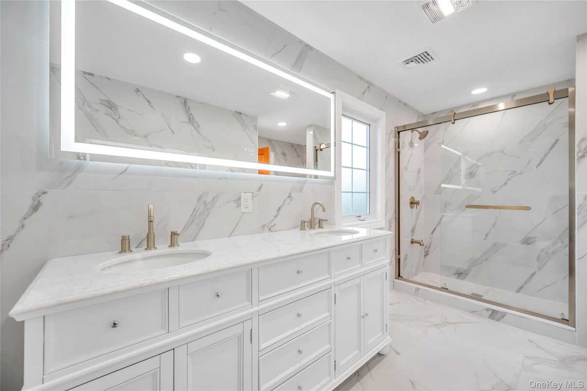 Bathroom, Dual Sink Vanities, Glass Shower, Interior, Marble, Marble Walls, Recessed Lighting