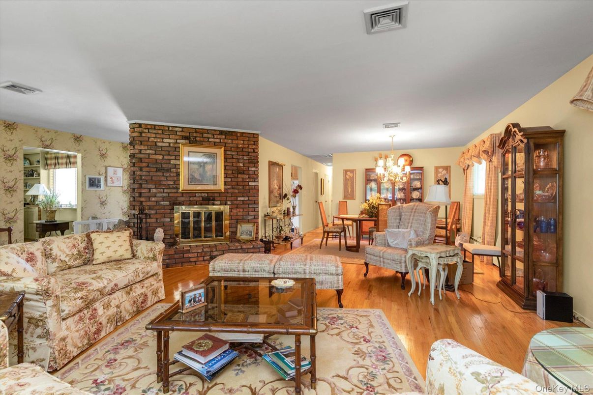 Chandelier, Dining room, Fireplace, Interior, Living room, Stone Walls, Wood Texture Flooring