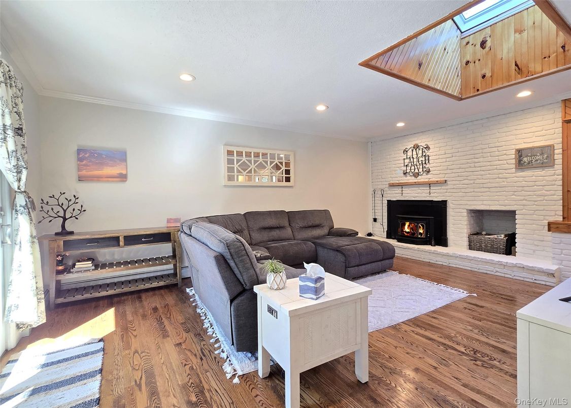 Fireplace, Interior, Living room, Recessed Lighting, Stone Walls, Wood Texture Flooring