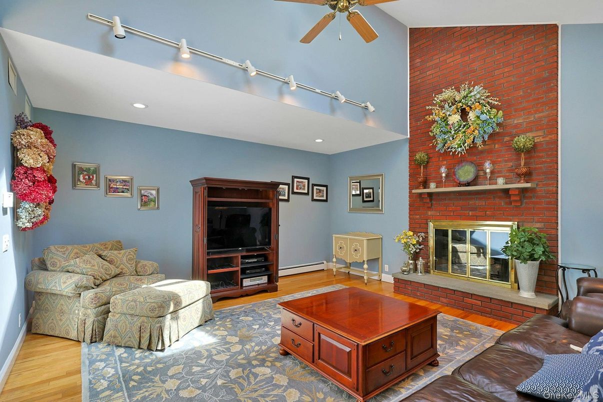 Fireplace, Interior, Living room, Recessed Lighting, Stone Walls, Wood Texture Flooring