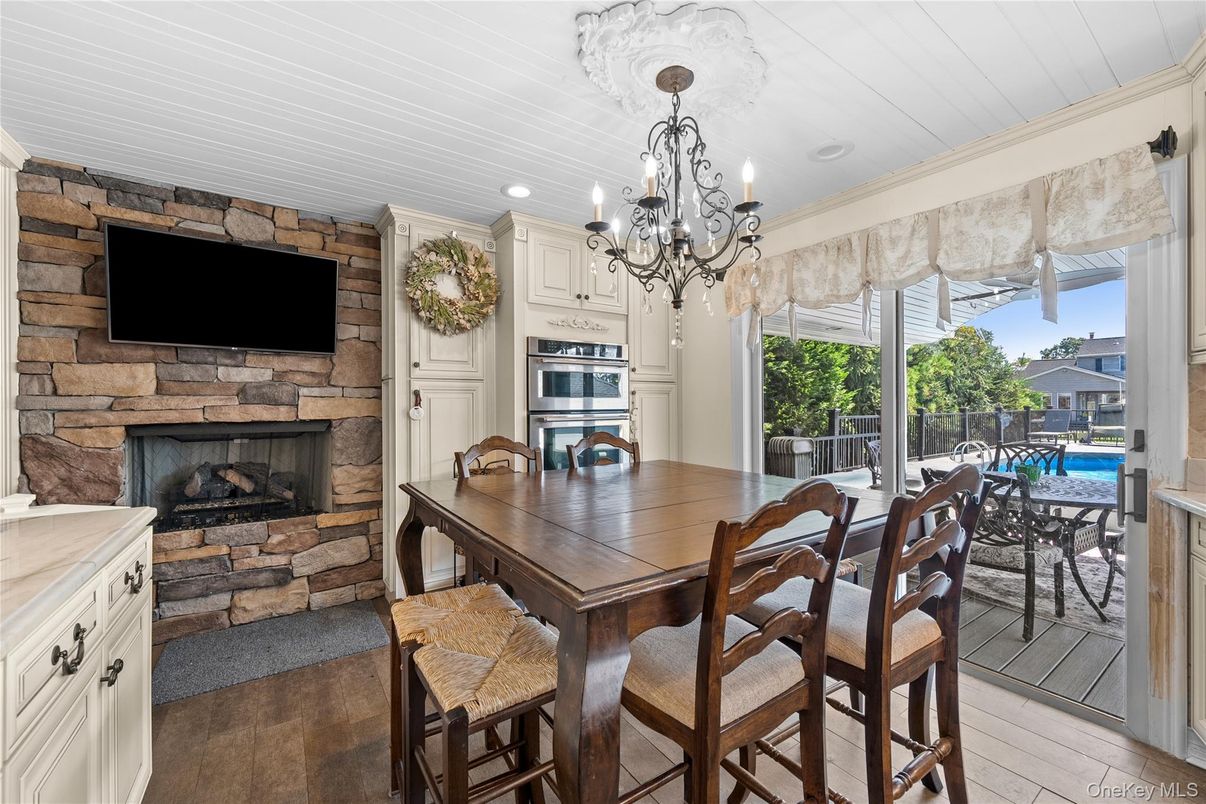Chandelier, Dining room, Fireplace, Interior, Kitchen, Recessed Lighting, Stone Walls, Wood Texture Flooring