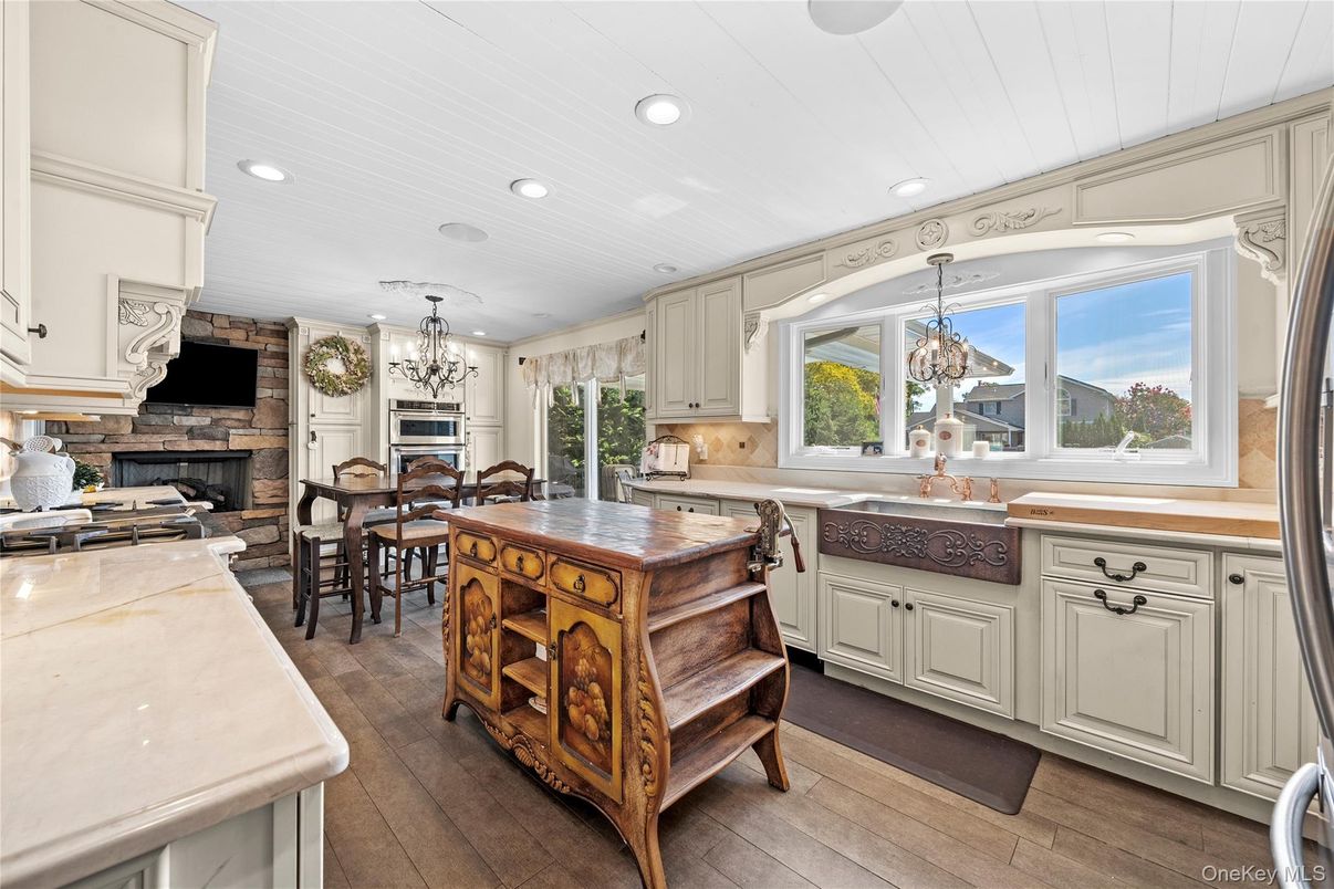 Chandelier, Dining room, Fireplace, Interior, Kitchen, Recessed Lighting, Wood Texture Flooring