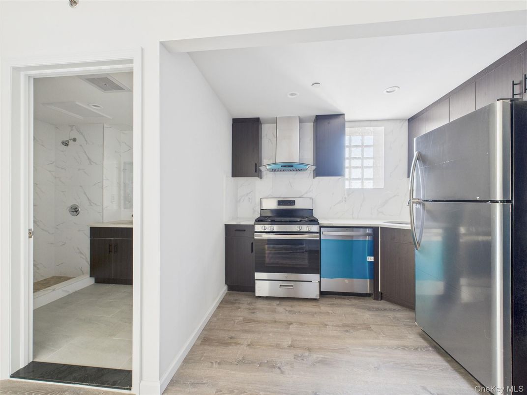 Interior, Kitchen, Marble Walls, Recessed Lighting, Stainless Steel Appliances, Wood Texture Flooring