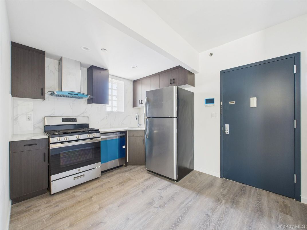 Interior, Kitchen, Marble Walls, Recessed Lighting, Stainless Steel Appliances, Wood Texture Flooring