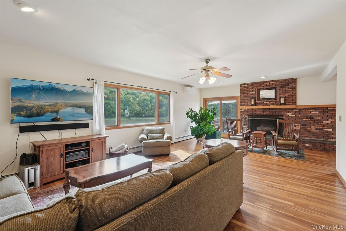 Dining room, Fireplace, Interior, Living room, Recessed Lighting, Stone Walls, Wood Texture Flooring
