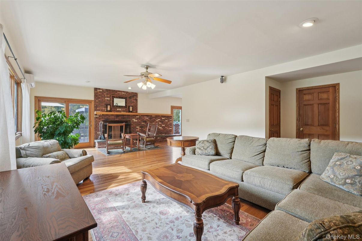 Dining room, Fireplace, Interior, Living room, Recessed Lighting, Stone Walls, Wood Texture Flooring