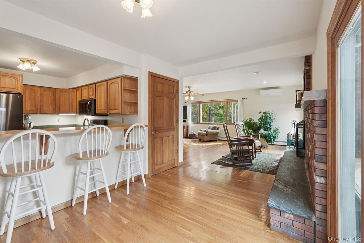 Fireplace, Interior, Kitchen, Living room, Recessed Lighting, Stainless Steel Appliances, Wood Texture Flooring