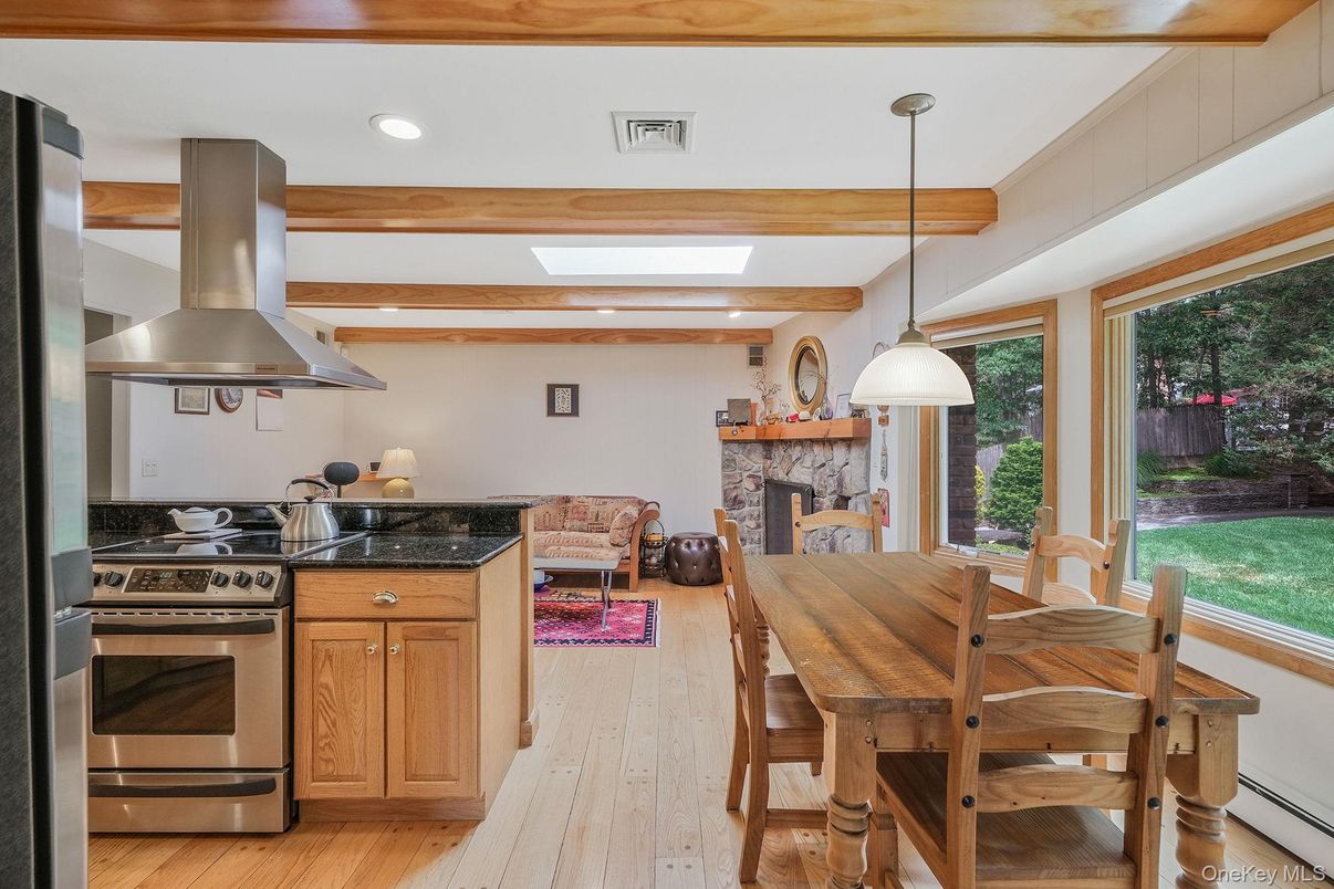 Dining room, Fireplace, Interior, Kitchen, Pendant Lights, Recessed Lighting, Stainless Steel Appliances, Stone Walls, Wooden Beams, Wood Texture Flooring