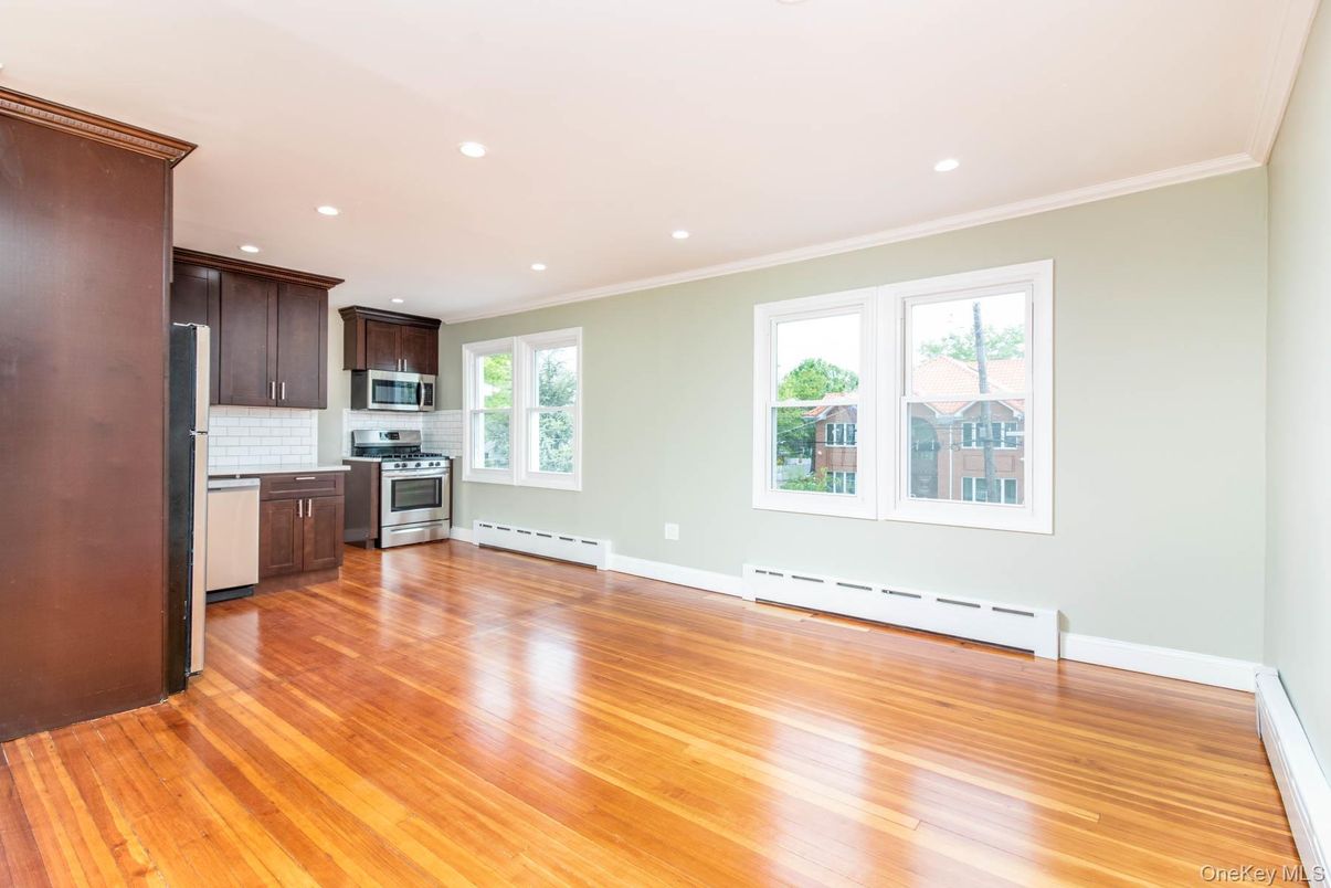 Empty room, Interior, Kitchen, Recessed Lighting, Stainless Steel Appliances, Wood Texture Flooring