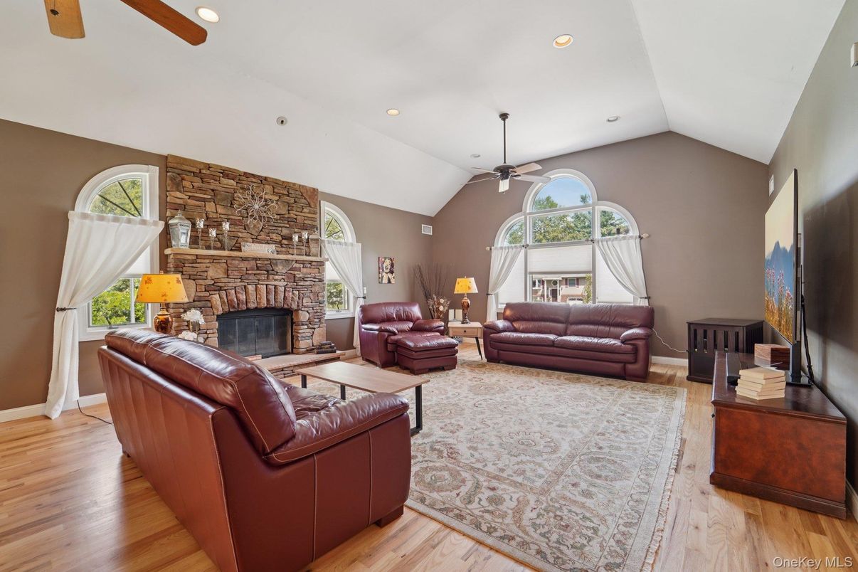 Fireplace, Interior, Living room, Recessed Lighting, Stone Walls, Wood Texture Flooring