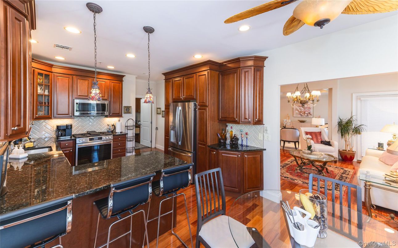 Chandelier, Dining room, Interior, Kitchen, Living room, Pendant Lights, Recessed Lighting, Stainless Steel Appliances, Wood Texture Flooring